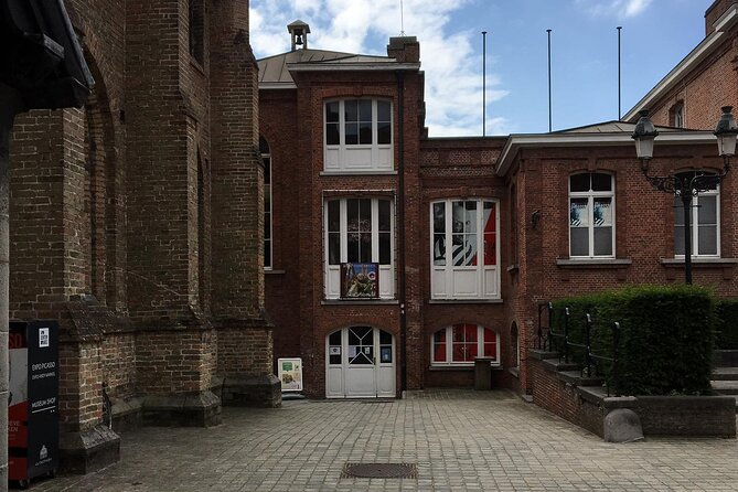 Bruges’ Legends and Hidden Treasures: A Self-Guided Audio Tour - Gruuthuse Palace and the Old Saint John’s Hospital Symbol